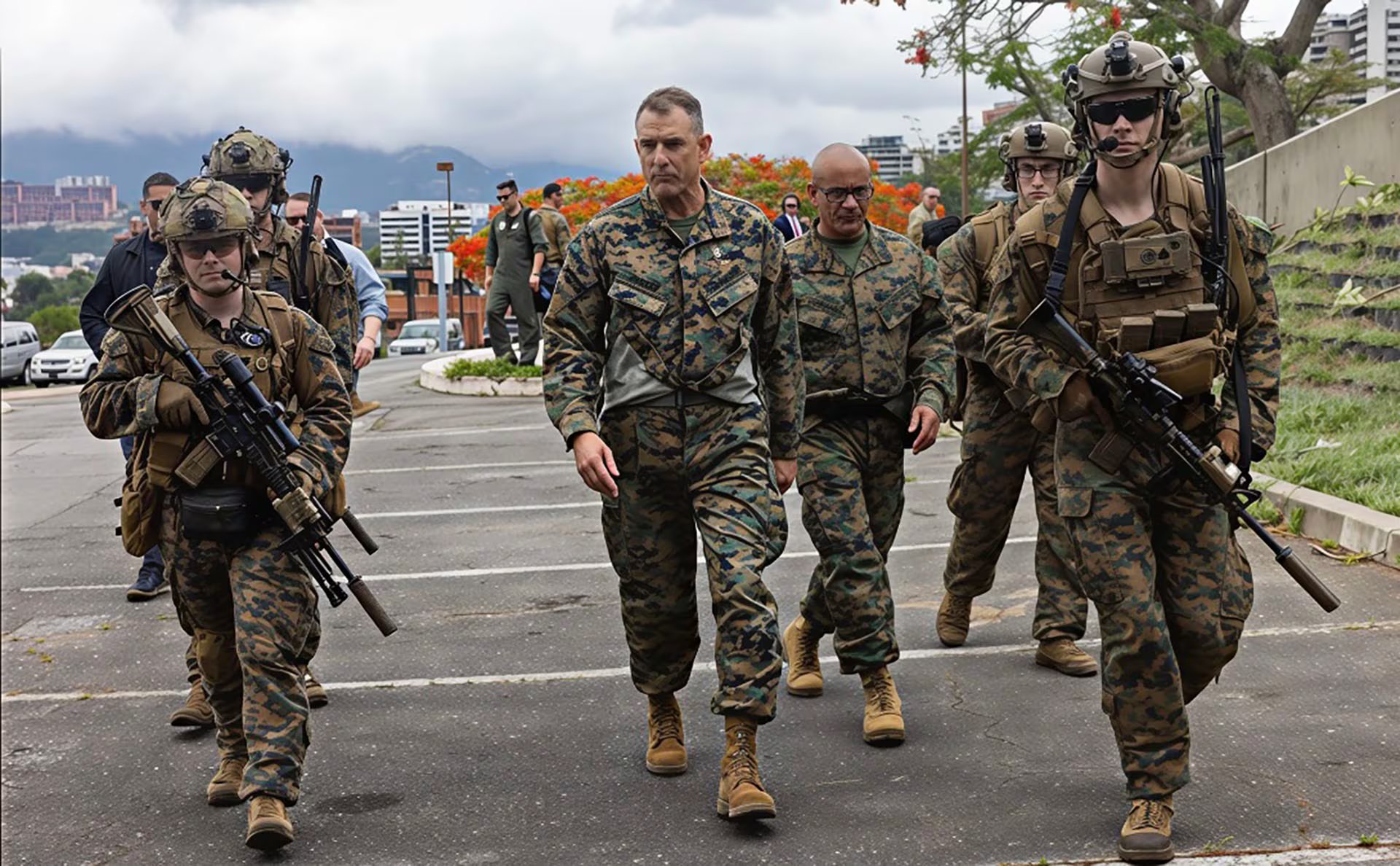 Varios militares equipados con uniformes de camuflaje y equipo táctico, incluyendo rifles, caminan por una carretera al aire libre bajo un cielo nublado (Associated Press)