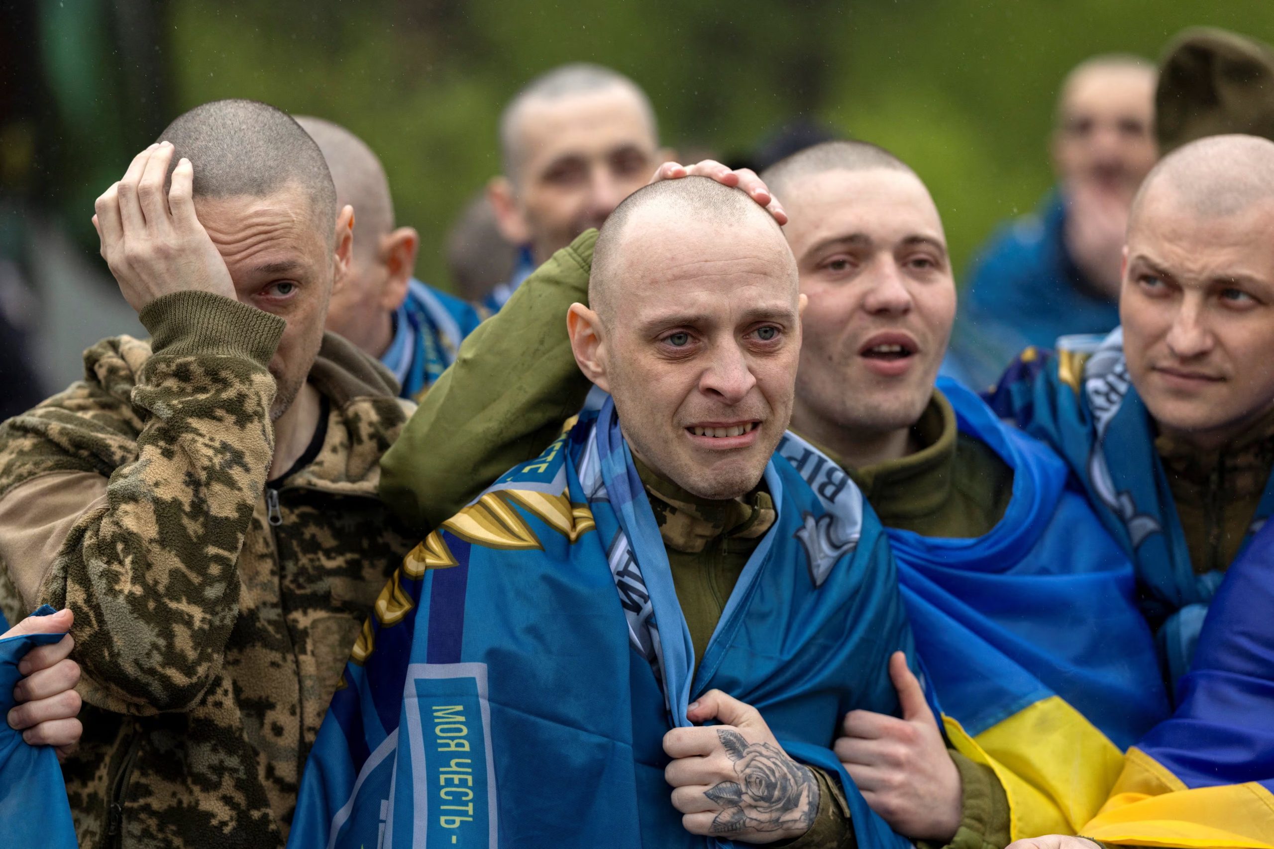 Soldados ucranianos y ex prisioneros de guerra reaccionan tras pisar suelo ucraniano después de un intercambio de prisioneros de guerra con Rusia (REUTERS/Thomas Peter)