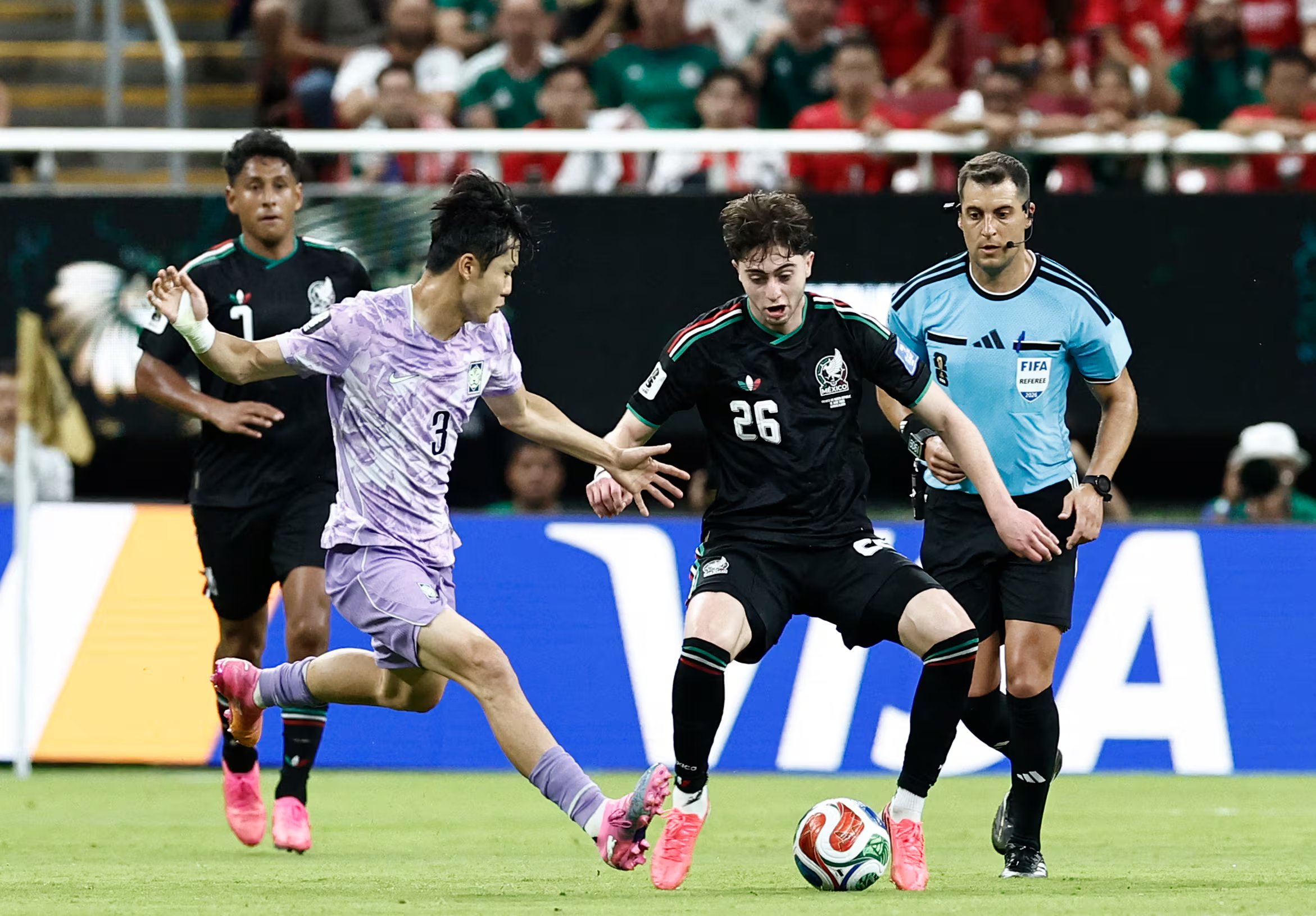 South Korea's defender #03 Lee Gi-hyuk and Mexico's midfielder #26 Brian Gutierrez fight for the ball during the 2026 World Cup Group A football match between Mexico and South Korea at the Guadalajara Stadium in Zapopan on June 18, 2026. (Photo by Ulises RUIZ / AFP)