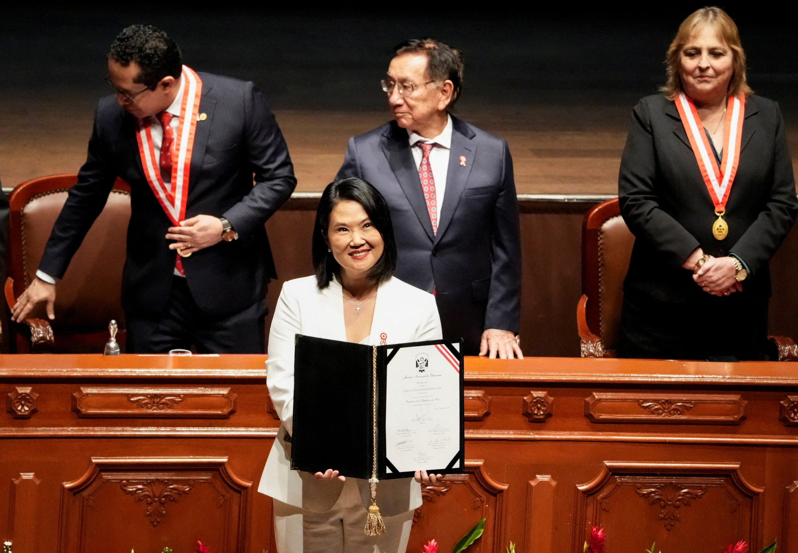 Peru's President-elect Keiko Fujimori, flanked by Peru's Interim President, Jose Maria Balcazar and Roberto Burneo, president of the National Elections Jury (JNE), holds the official credentials she received from Burneo, following her victory in the presidential runoff after the June 7 election, in Lima, Peru, July 15, 2026. REUTERS/Angela Ponce