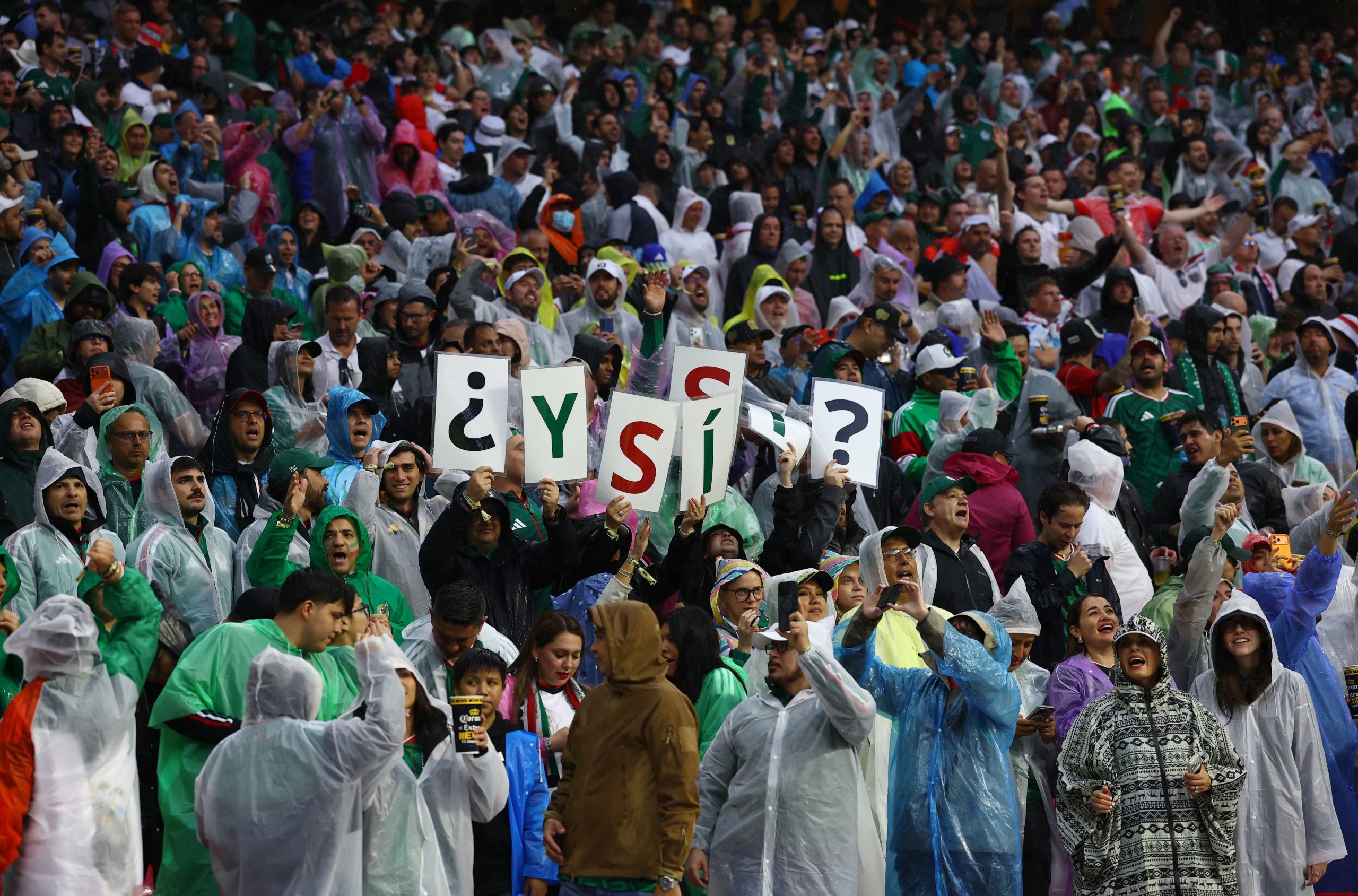 Soccer Football - FIFA World Cup 2026 - Round of 16 - Mexico v England - Estadio Azteca, Mexico City, Mexico - July 5, 2026 Mexico fans wear rain ponchos inside the stadium before the match after kick off has been delayed due to the weather REUTERS/Daniel Becerril
