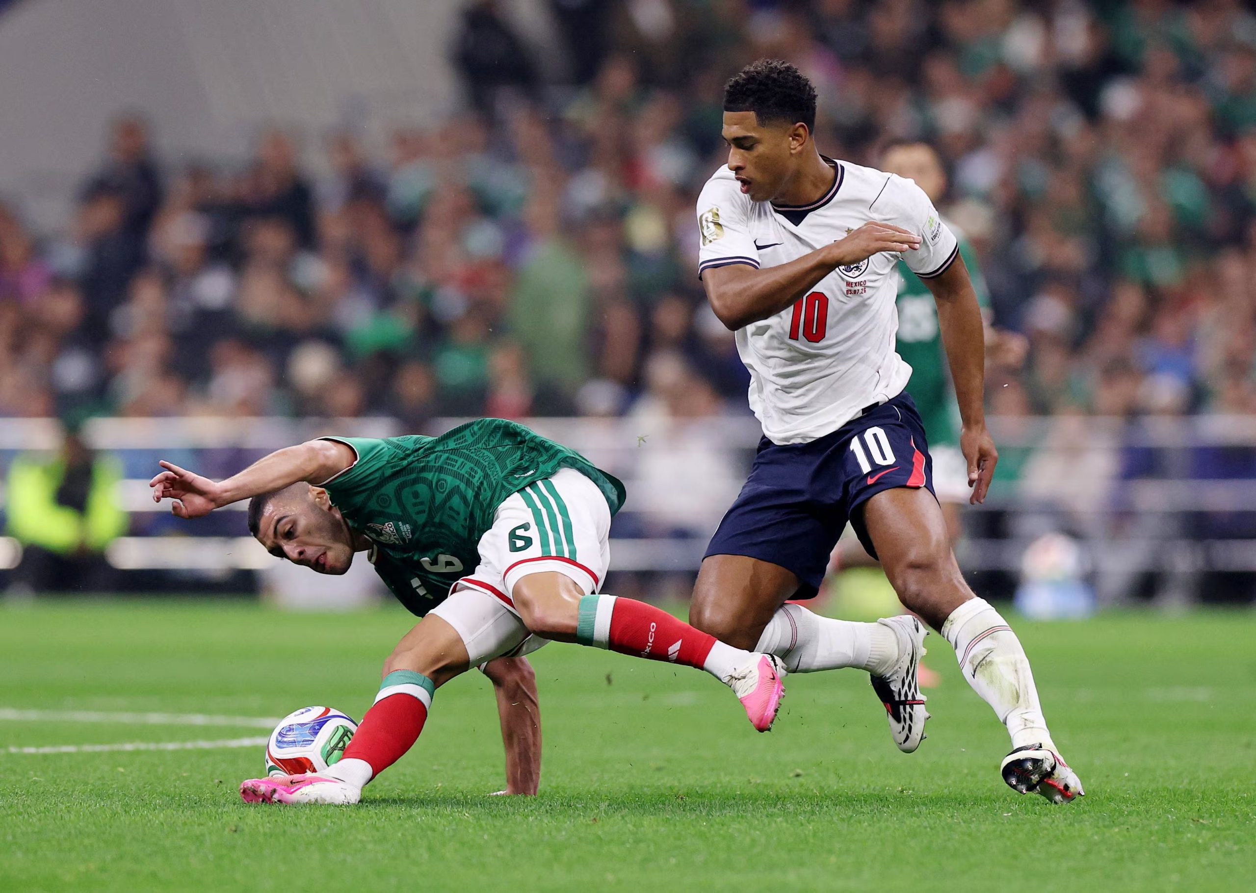 Soccer Football - FIFA World Cup 2026 - Round of 16 - Mexico v England - Estadio Azteca, Mexico City, Mexico - July 5, 2026 Mexico's Erik Lira in action with England's Jude Bellingham REUTERS/Raquel Cunha