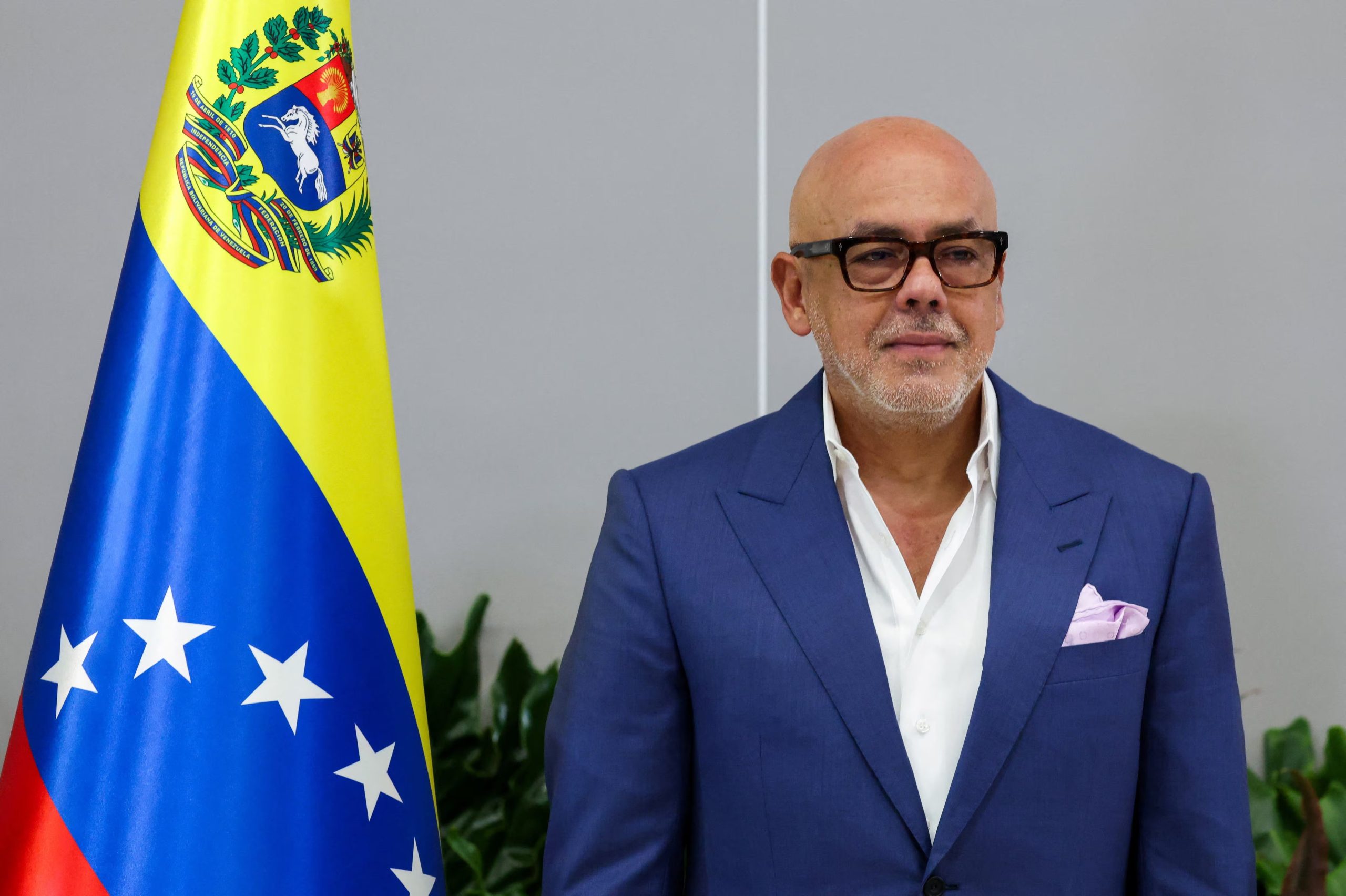 Venezuela's National Assembly President Jorge Rodriguez poses next to the Venezuelan flag, as he attends the opening session of the national dialogue in Caracas, Venezuela, August 6, 2026. REUTERS/Leonardo Fernandez Viloria