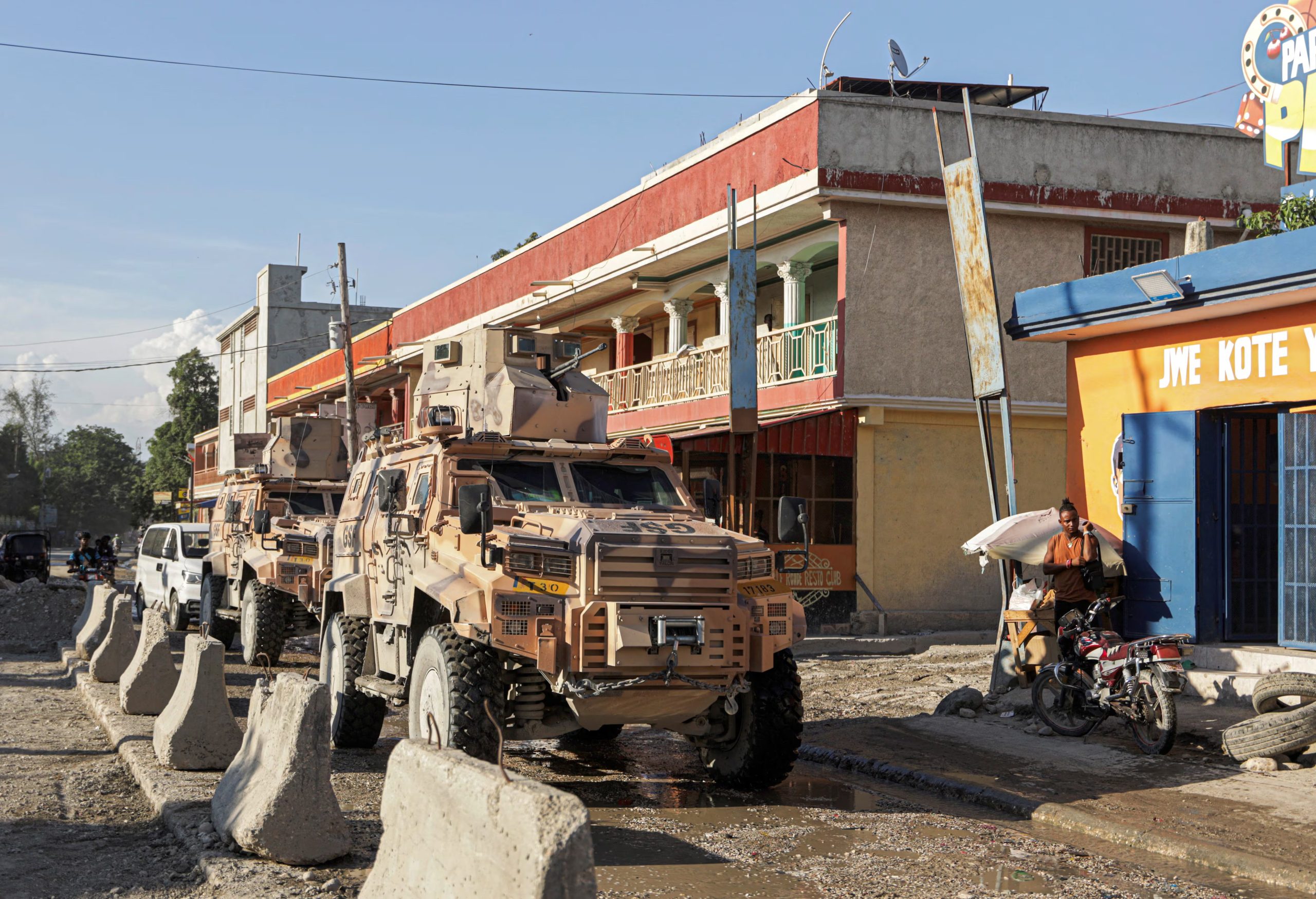 Armored personnel carriers of Haiti's UN-backed Gang Suppression Force (GSF) patrol an area after heavily armed gangs ambushed members of the force, attacking their armored vehicle with explosives, setting it ablaze and leaving four Salvadoran troops missing when they fled their burning vehicle, in Port-au-Prince, Haiti, October 19, 2026. REUTERS/Patrice Noel